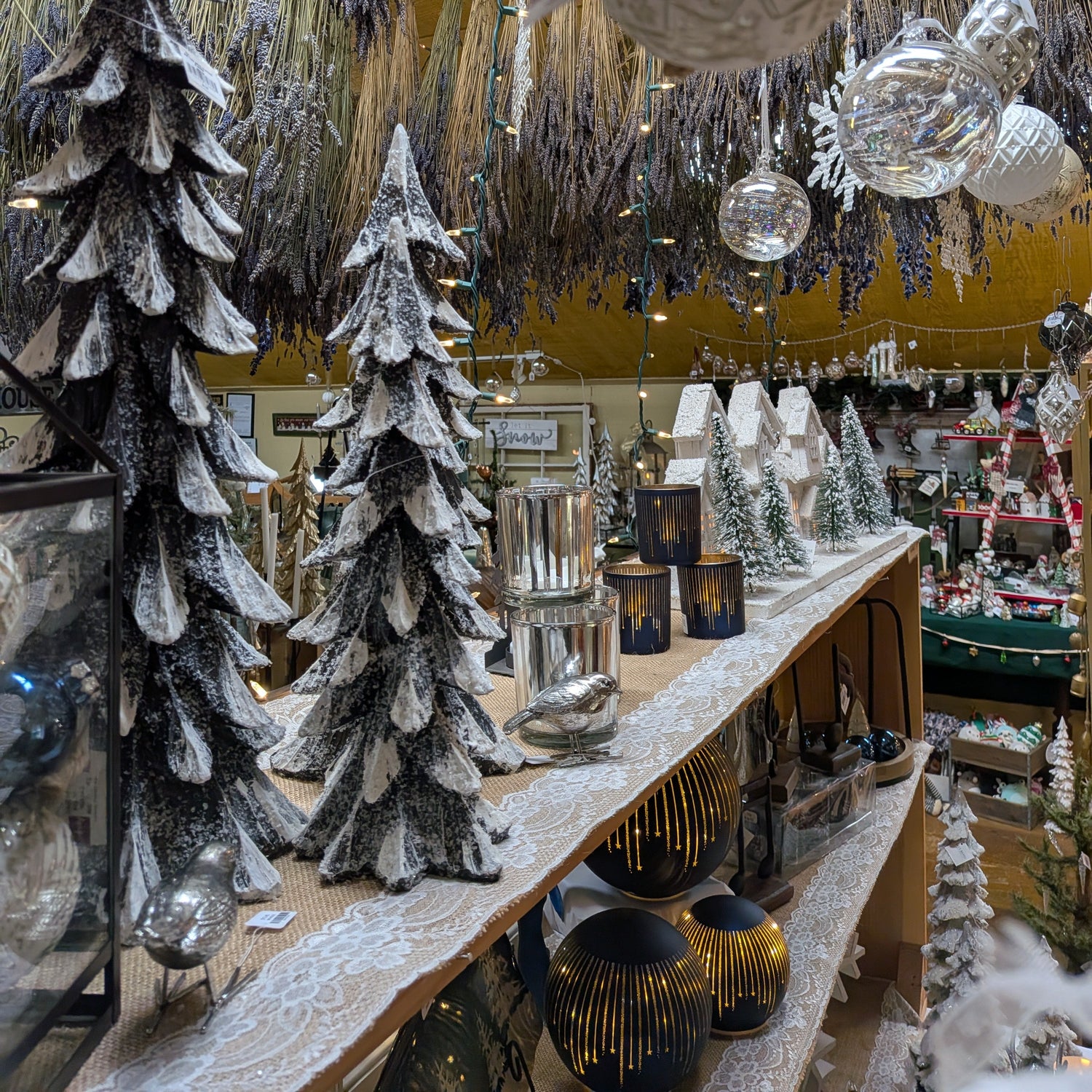 Decorative Christmas trees and ornaments in a store setting